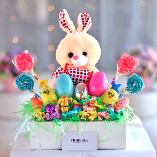 Stuffed rabbit with candy lollipops and Easter eggs